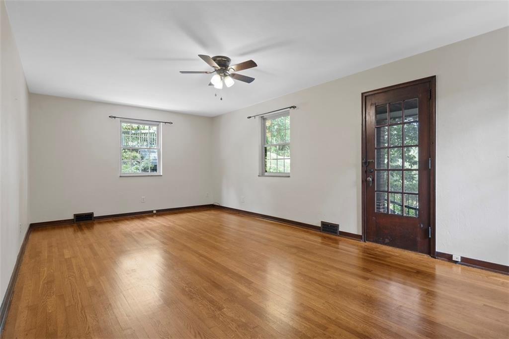 21 Bryn Mawr Road Pittsburgh, PA 15221 - Photo 4 of 42 a view of an empty room with a window and wooden floor