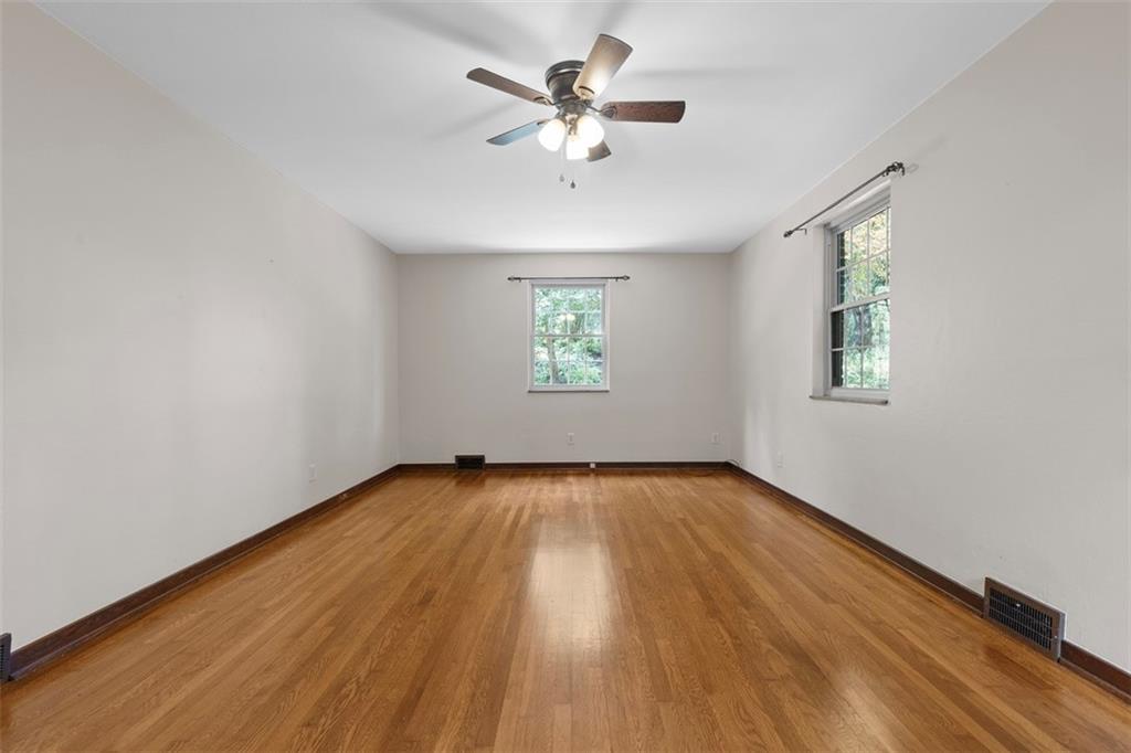 21 Bryn Mawr Road Pittsburgh, PA 15221 - Photo 5 of 42 wooden floor in an empty room with a window
