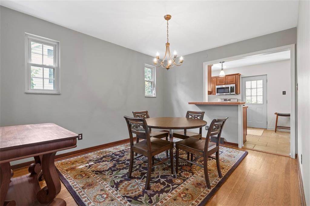 21 Bryn Mawr Road Pittsburgh, PA 15221 - Photo 10 of 42 a view of a dining room with furniture wooden floor and a chandelier