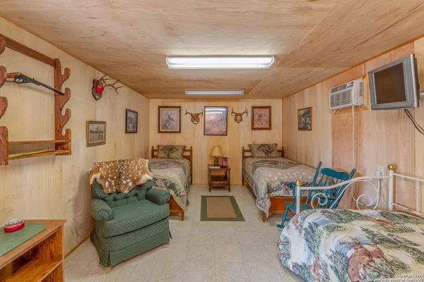 a bedroom with furniture and a flat screen tv