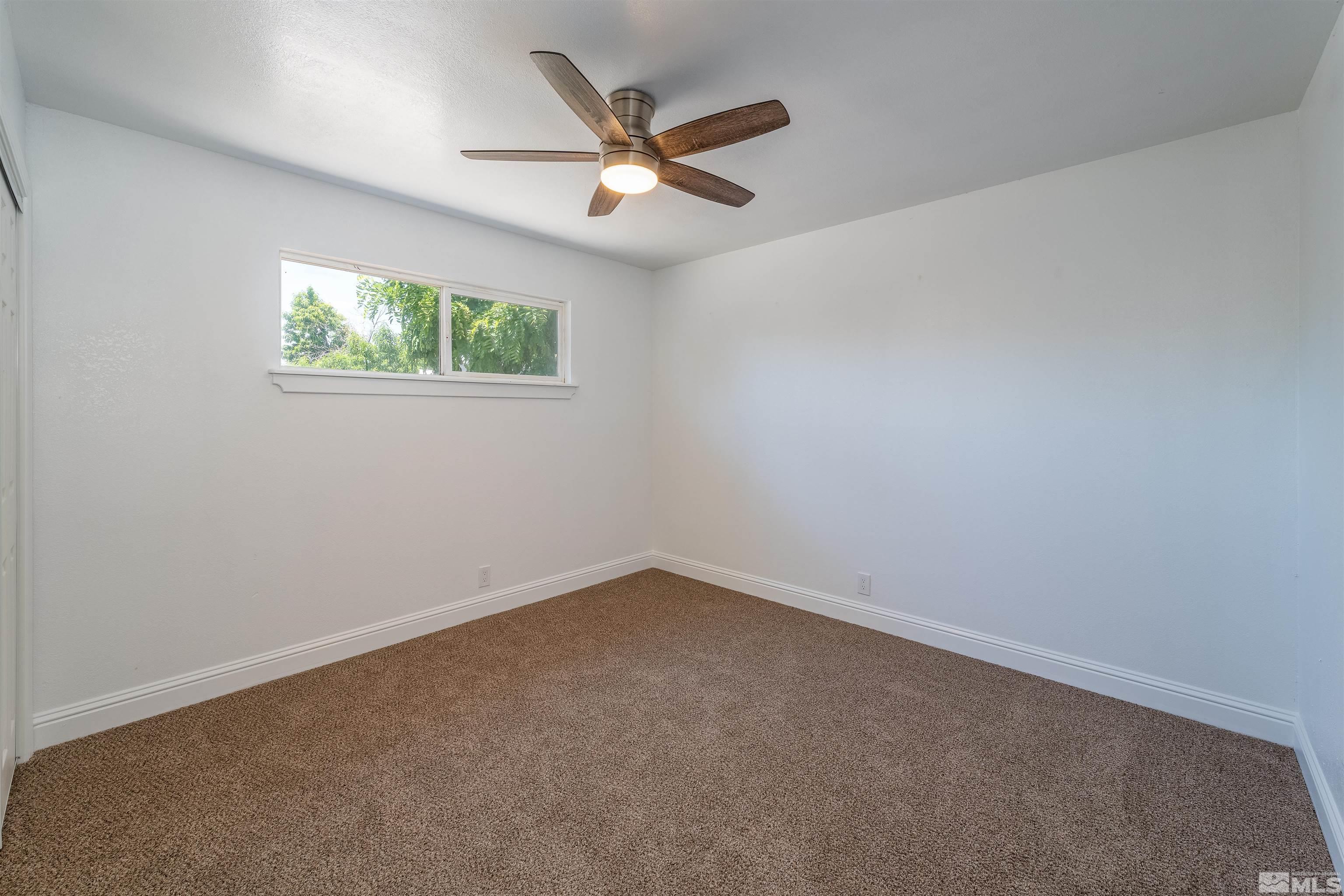 1815 Radcliffe Drive Reno, NV 89502 - Photo 13 of 22 an empty room with a window and a ceiling fan
