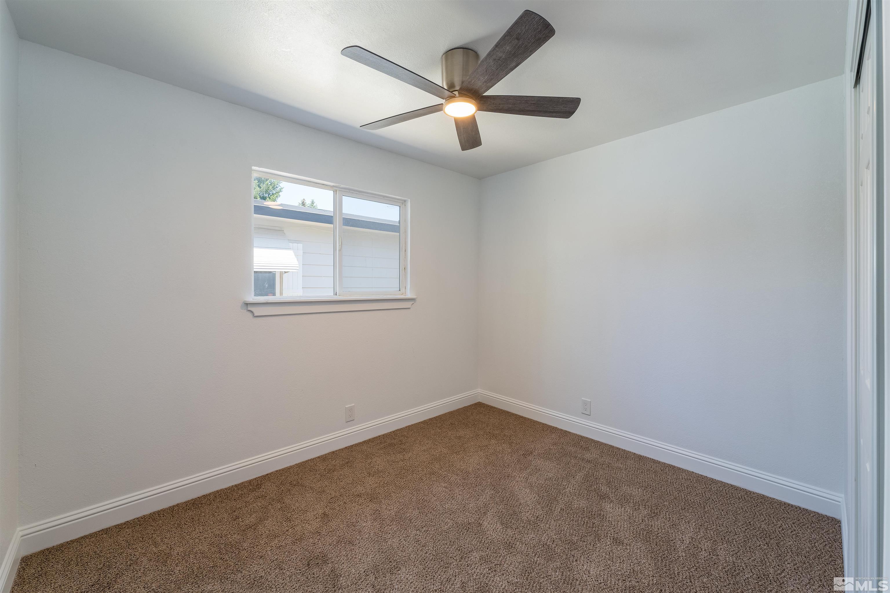 1815 Radcliffe Drive Reno, NV 89502 - Photo 15 of 22 an empty room with a window and a fan