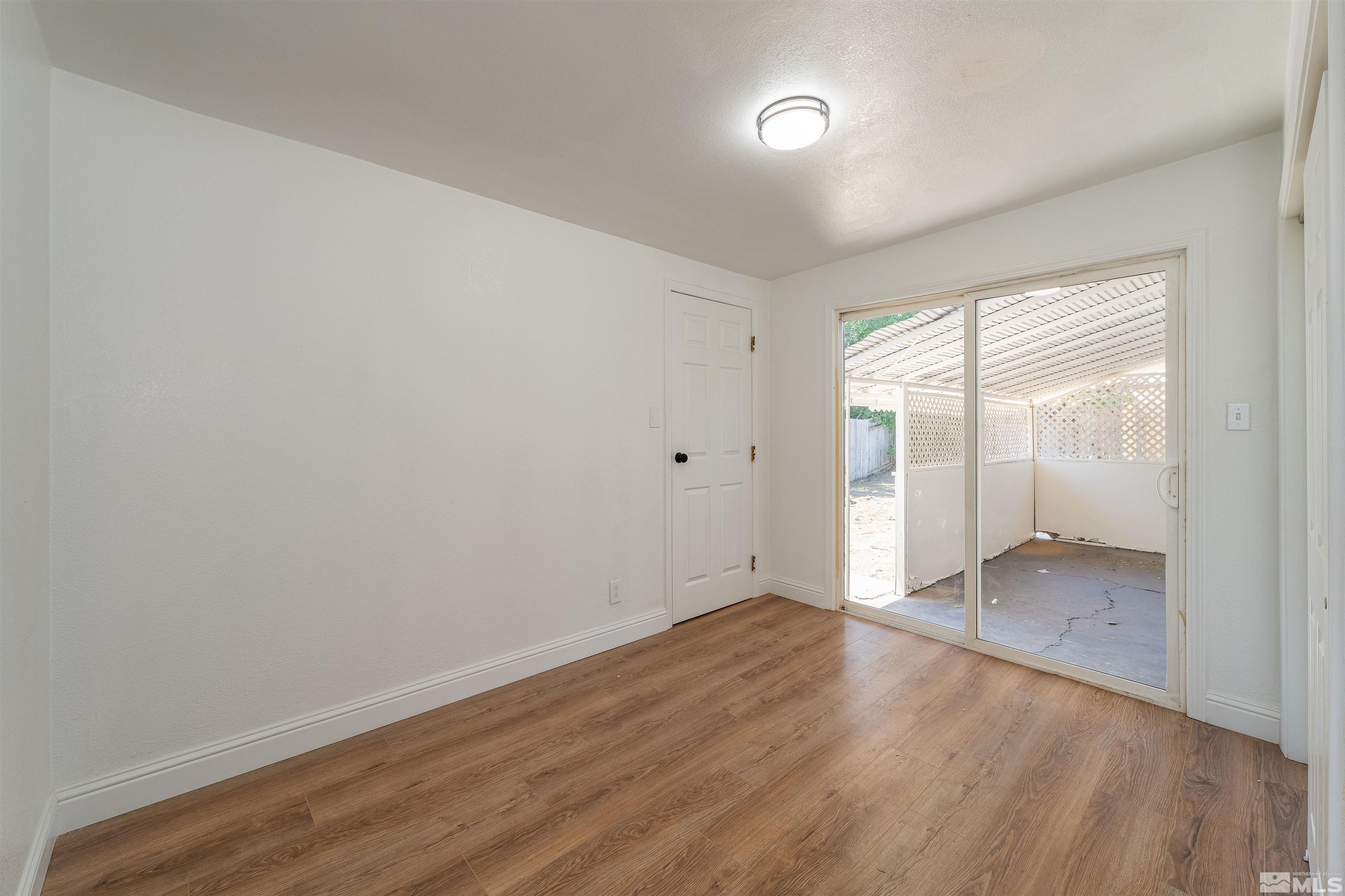 1815 Radcliffe Drive Reno, NV 89502 - Photo 18 of 22 wooden floor in an empty room with a window
