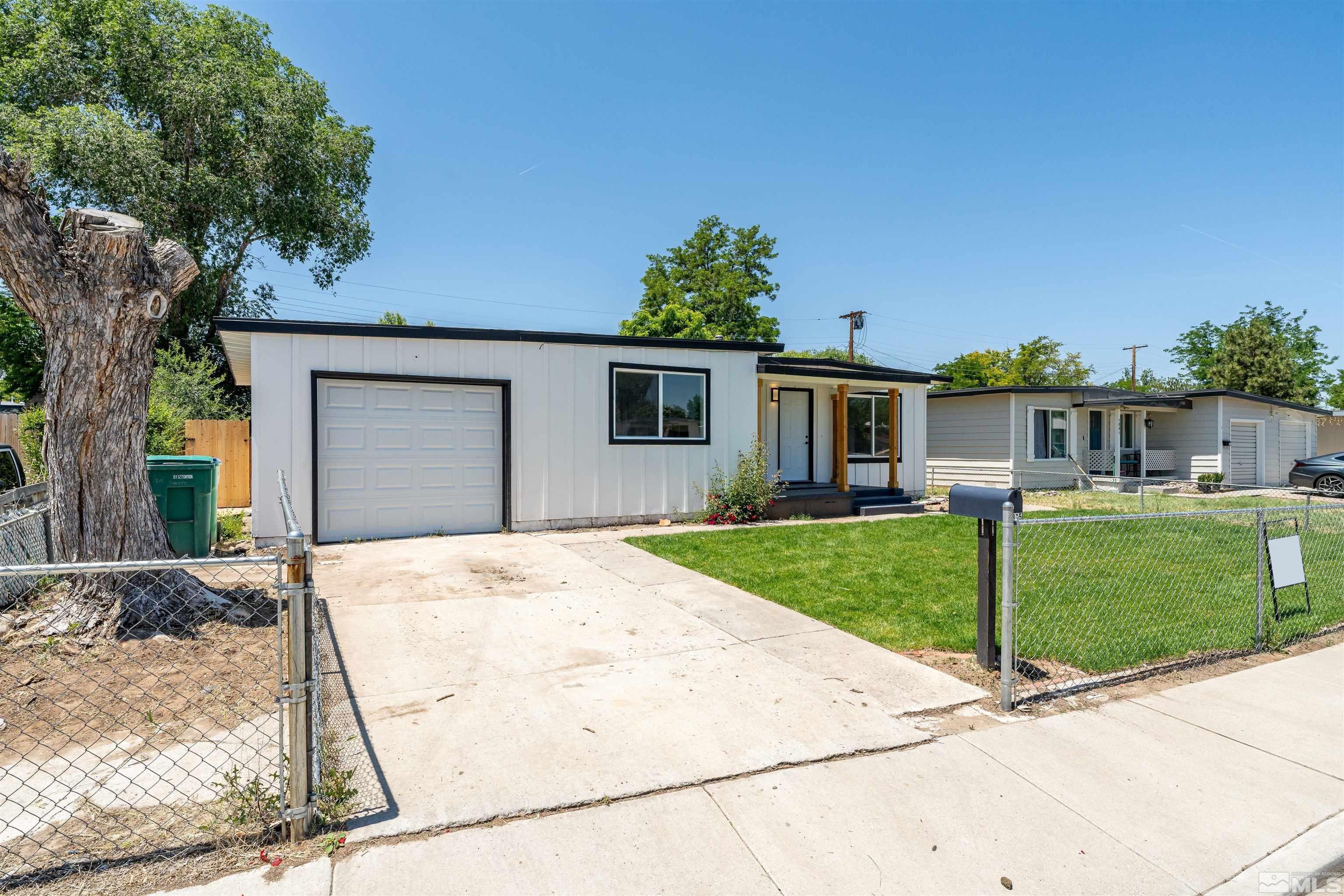 1815 Radcliffe Drive Reno, NV 89502 - Photo 3 of 22 a front view of a house with a yard and garage
