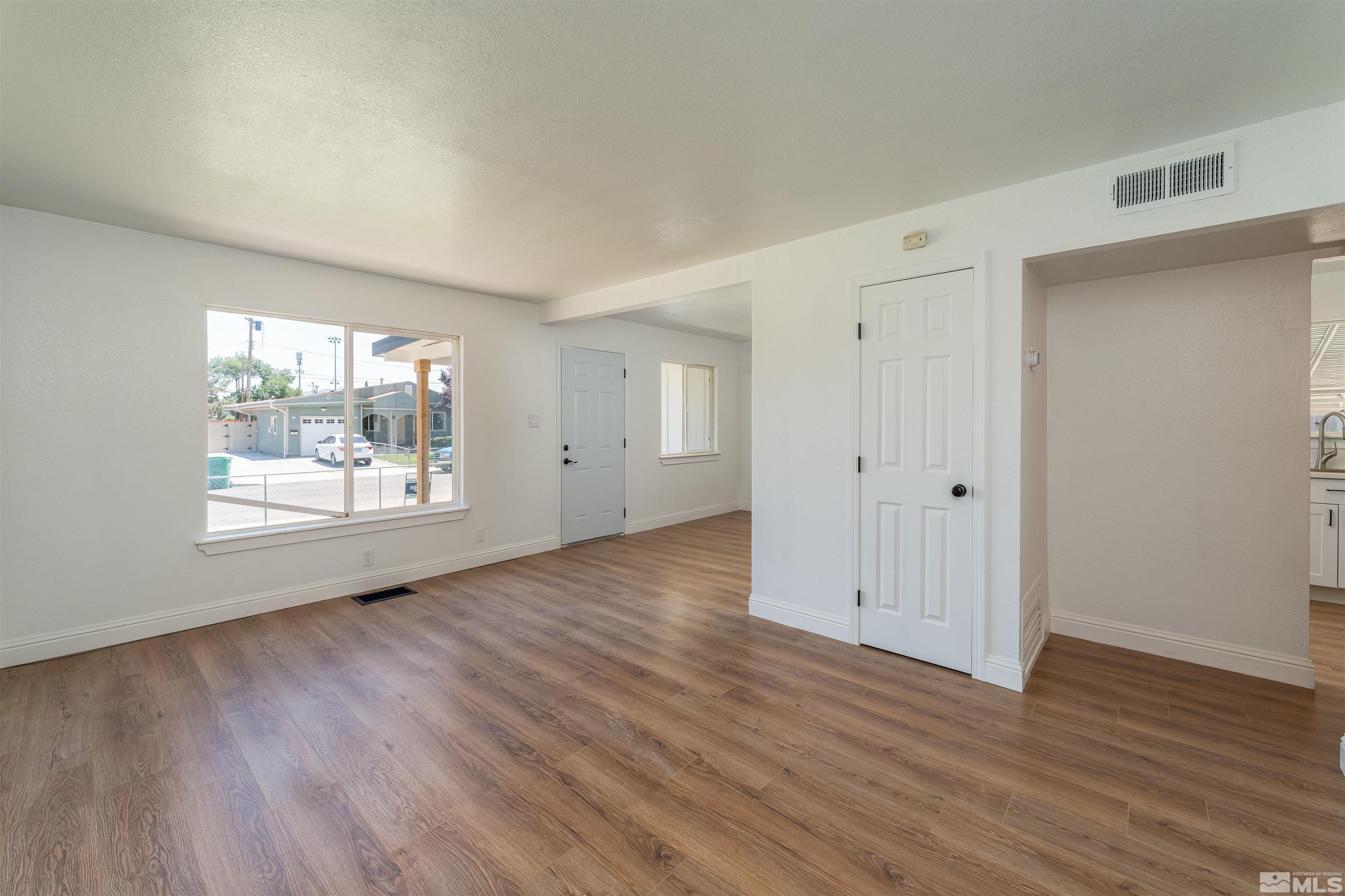 1815 Radcliffe Drive Reno, NV 89502 - Photo 5 of 22 an empty room with wooden floor and windows