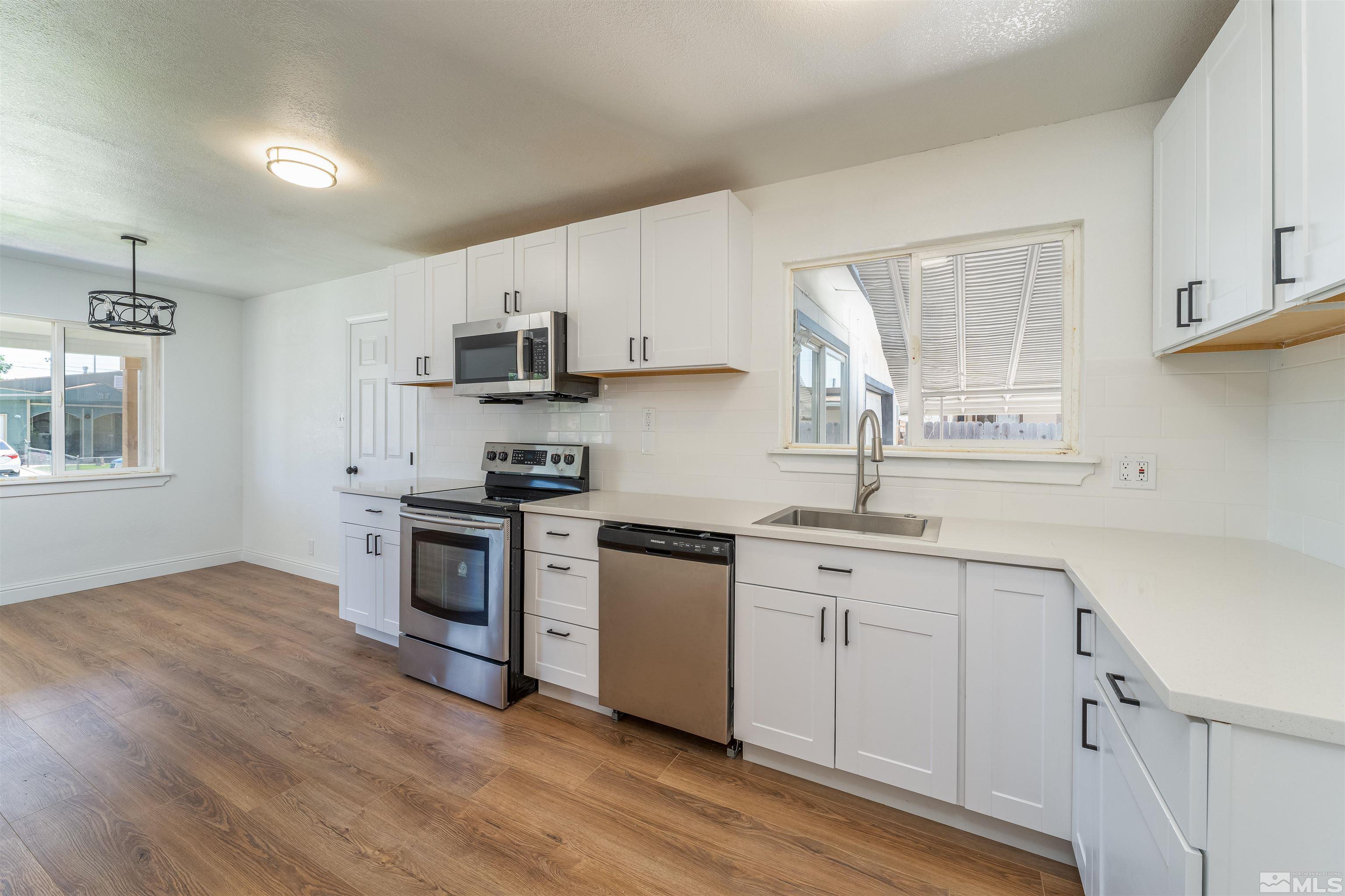 1815 Radcliffe Drive Reno, NV 89502 - Photo 9 of 22 a kitchen with granite countertop a sink cabinets and wooden floor