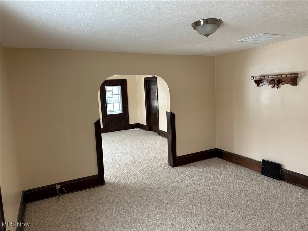 60 Taylor Road Barberton, OH 44203 - Photo 8 of 35 Carpeted dining room featuring a textured ceiling