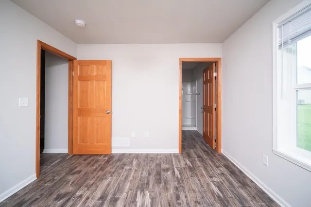 a view of hallway with wooden floor