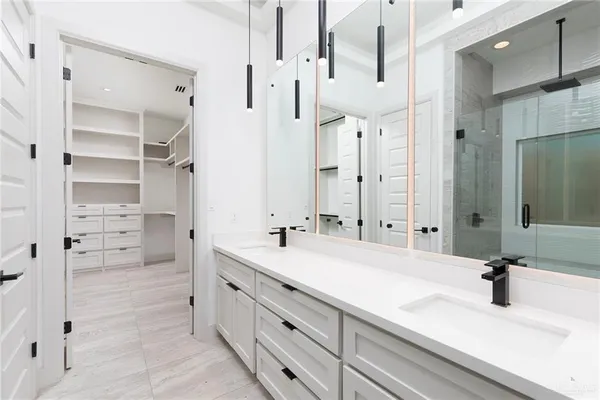 a bathroom with a double vanity sink mirror and double