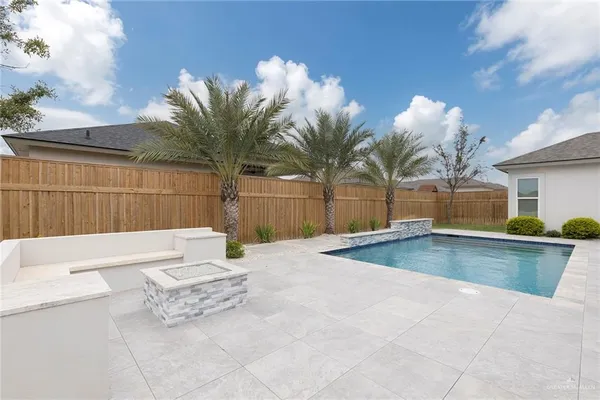 a view of a house with a swimming pool and a yard