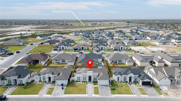 an aerial view of residential houses with outdoor space
