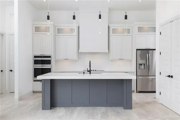 a kitchen with cabinets and stainless steel appliances