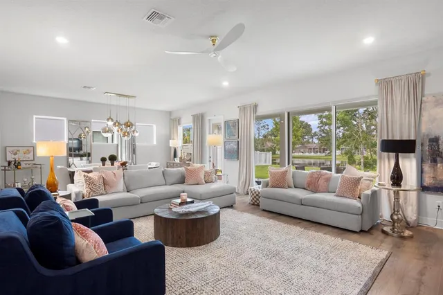 a living room with furniture and large windows