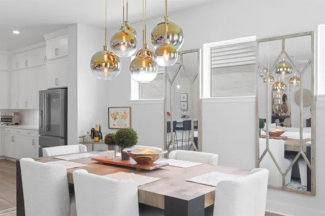 a dining room with furniture a chandelier and wooden floor