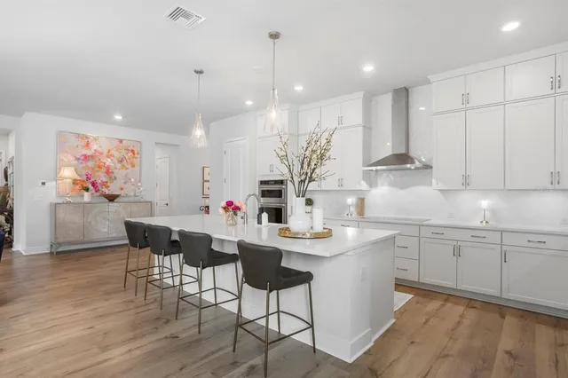 a large kitchen with a table and chairs