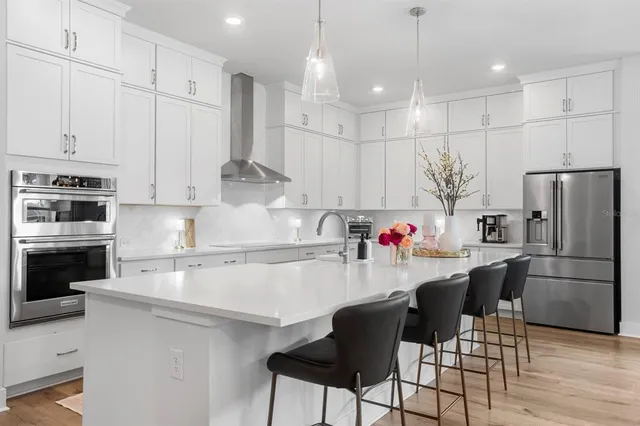 a large kitchen with stainless steel appliances kitchen island a large counter space a sink and cabinets