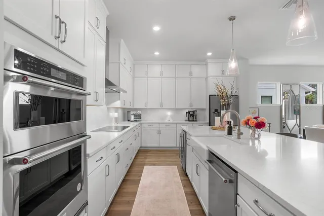 a bedroom with a large bed couch and a large window