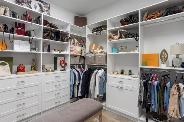 a bedroom with a bed a couch and a window