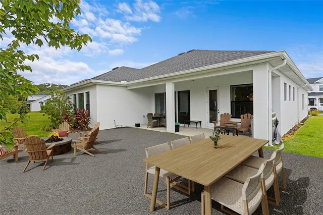 a view of a patio with table and chairs and potted plants