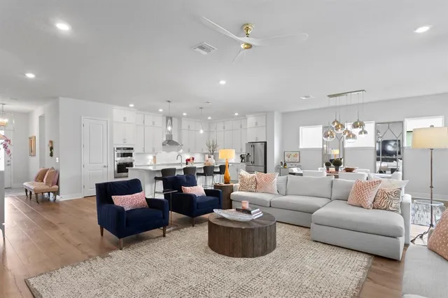 a living room with furniture and a view of kitchen