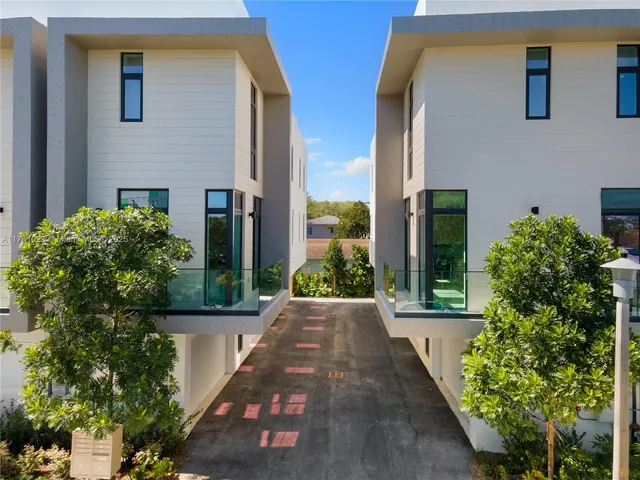 a view of a house with potted plants