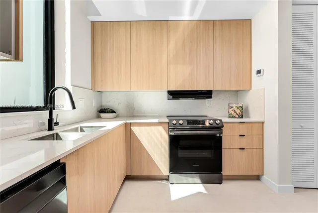 a kitchen with a table chairs refrigerator and microwave