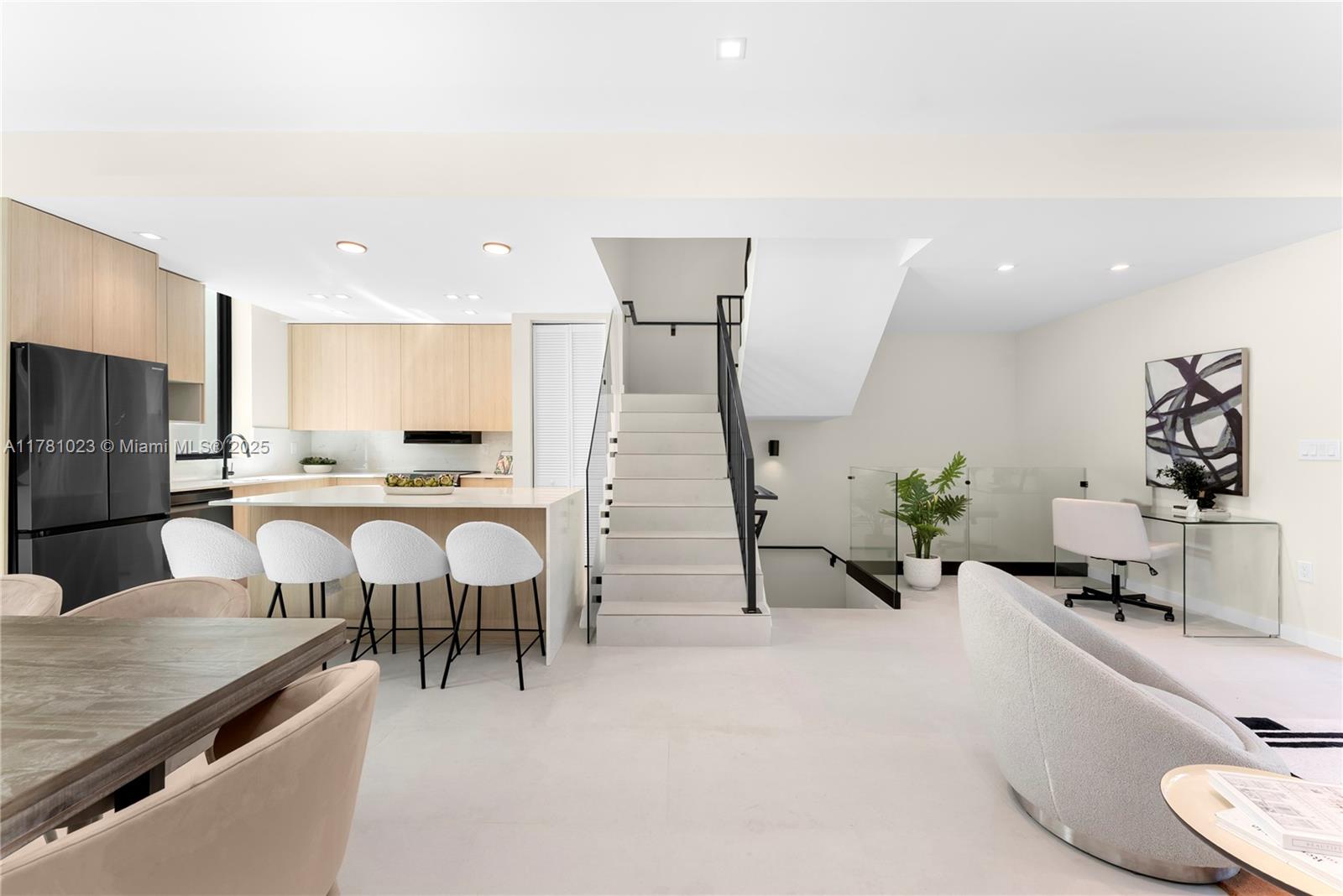 2501 Southwest 27th Street, Unit 2 Miami, FL 33133 - Photo 20 of 41 a kitchen with a table chairs refrigerator and microwave