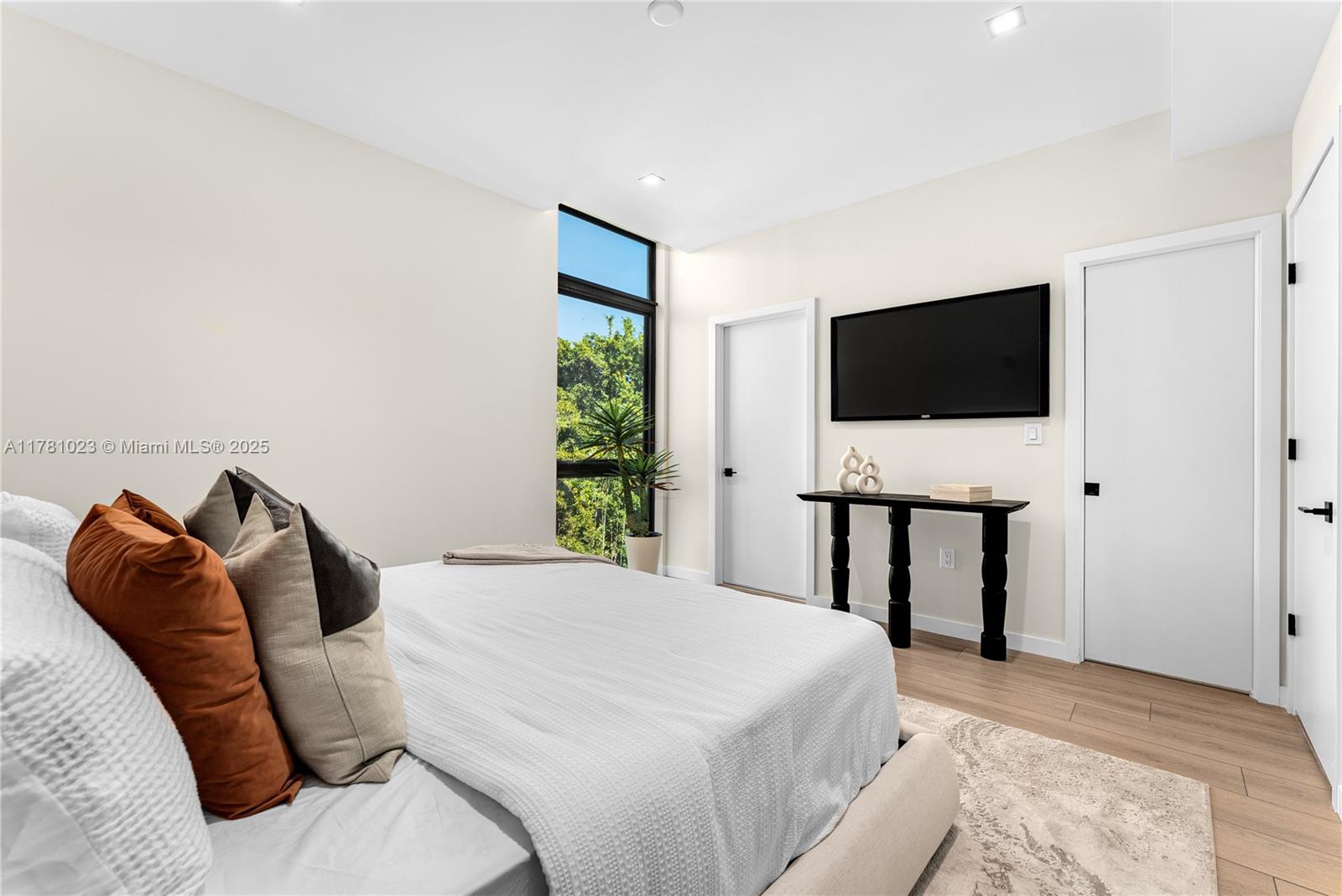 2501 Southwest 27th Street, Unit 2 Miami, FL 33133 - Photo 25 of 41 a bedroom with a bed and a flat screen tv