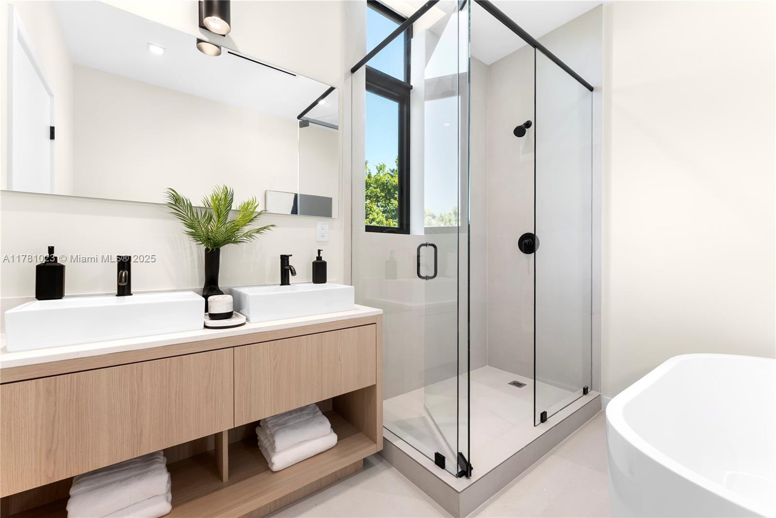 2501 Southwest 27th Street, Unit 2 Miami, FL 33133 - Photo 28 of 41 a bathroom with a sink a mirror and a shower