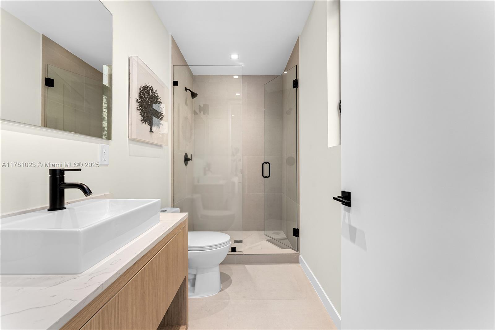 2501 Southwest 27th Street, Unit 2 Miami, FL 33133 - Photo 29 of 41 a bathroom with a bathtub shower sink vanity and toilet