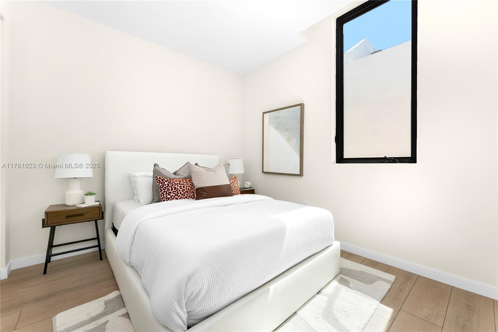 2501 Southwest 27th Street, Unit 2 Miami, FL 33133 - Photo 32 of 41 a bedroom with a bed and a painting on the wall