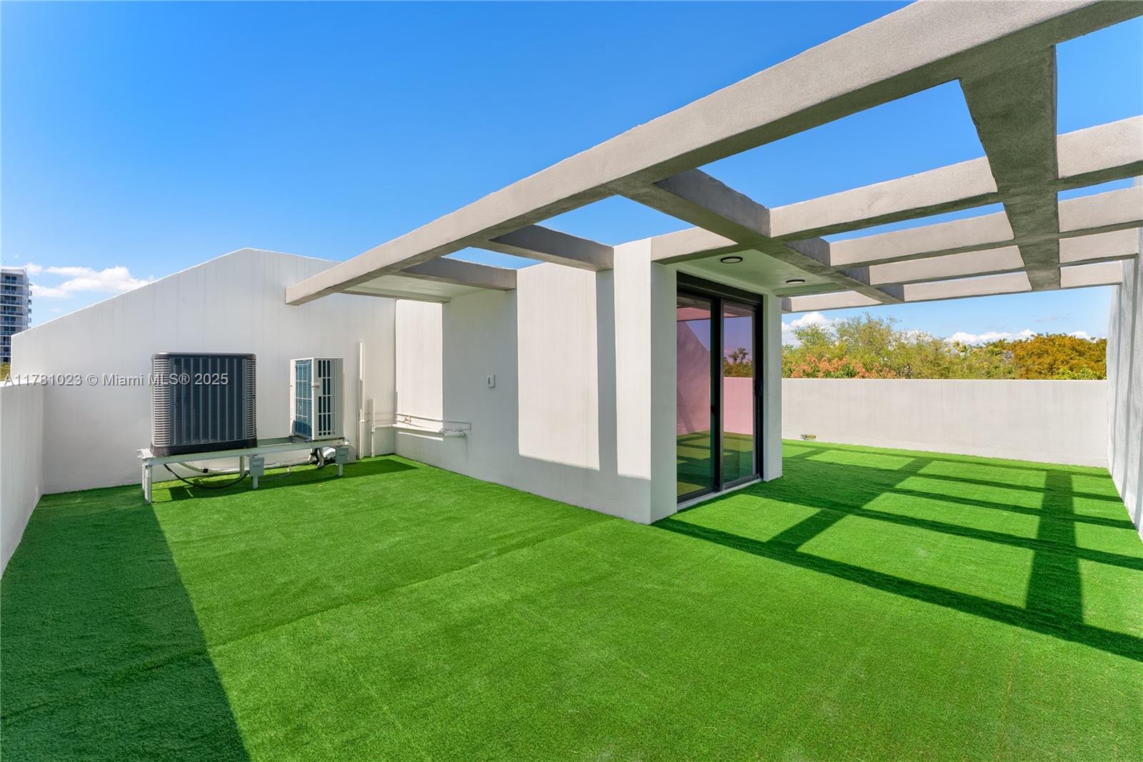 2501 Southwest 27th Street, Unit 2 Miami, FL 33133 - Photo 41 of 41 a view of a backyard with potted plants and floor to ceiling window