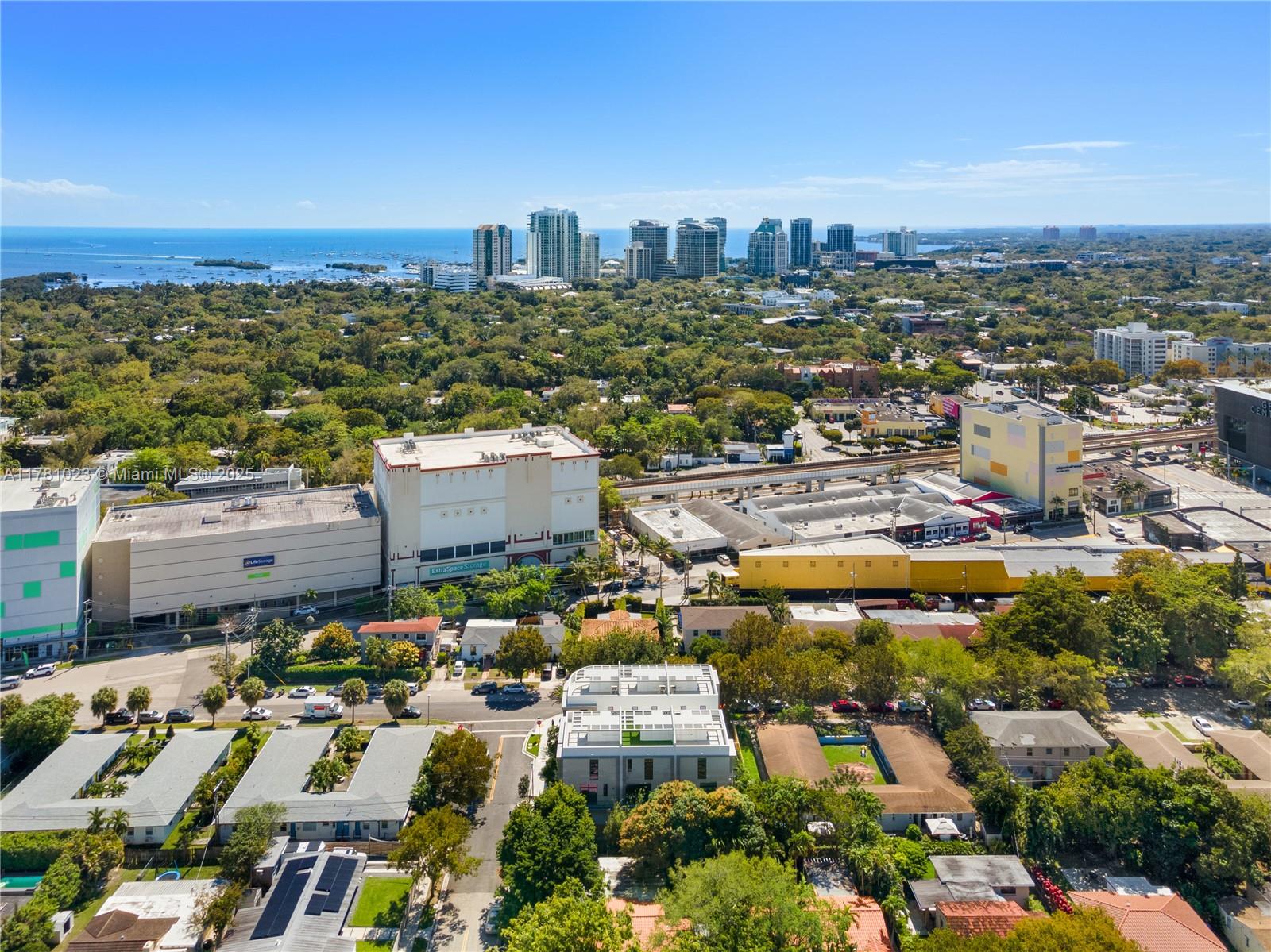 2501 Southwest 27th Street, Unit 2 Miami, FL 33133 - Photo 7 of 41 an aerial view of a city with lots of residential buildings ocean and mountain in back