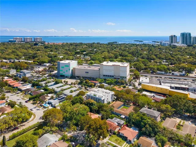 an aerial view of residential houses with city view