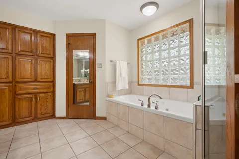 a bathroom with a tub a sink and a shower