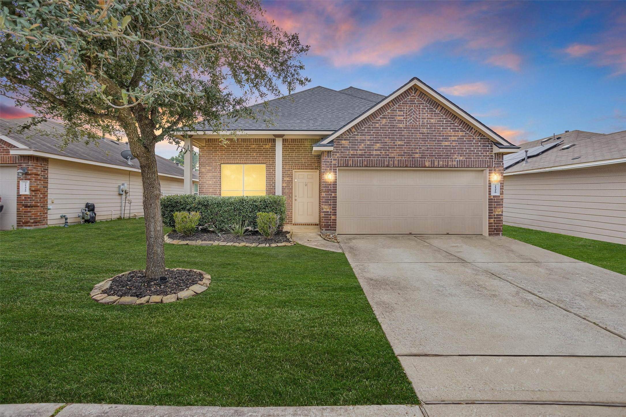 a front view of a house with a yard and garage
