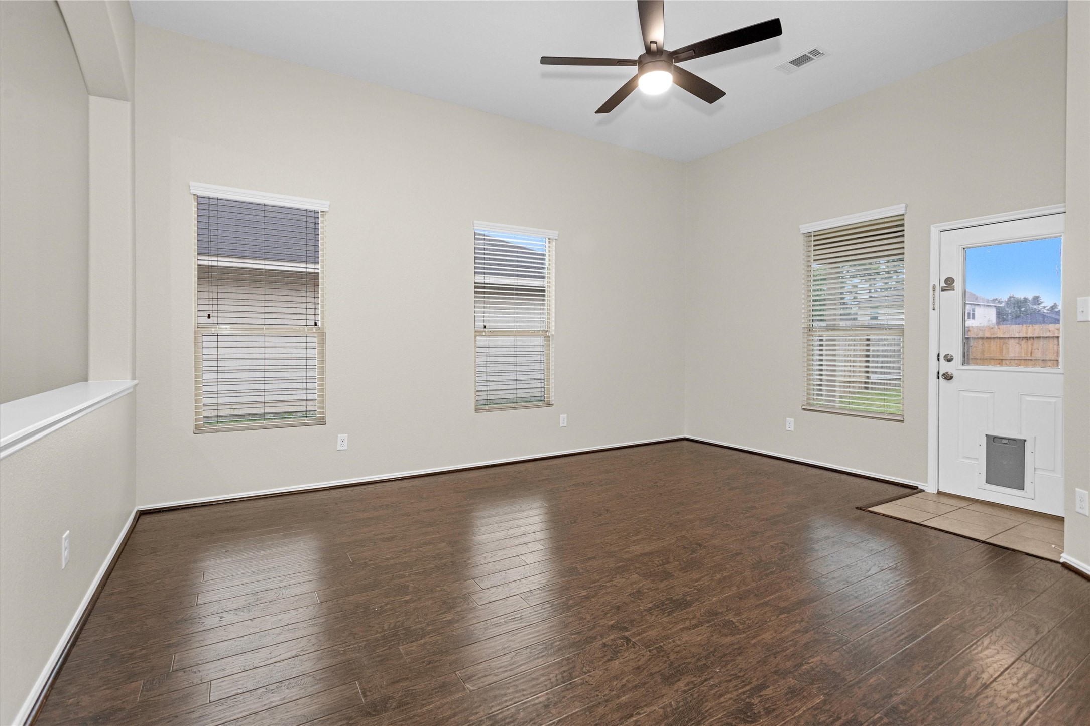 21419 Fossil Trails Drive Spring, TX 77388 - Photo 16 of 42 a view of an empty room with wooden floor and a window