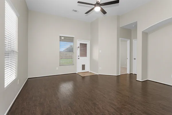wooden floor in an empty room with a window