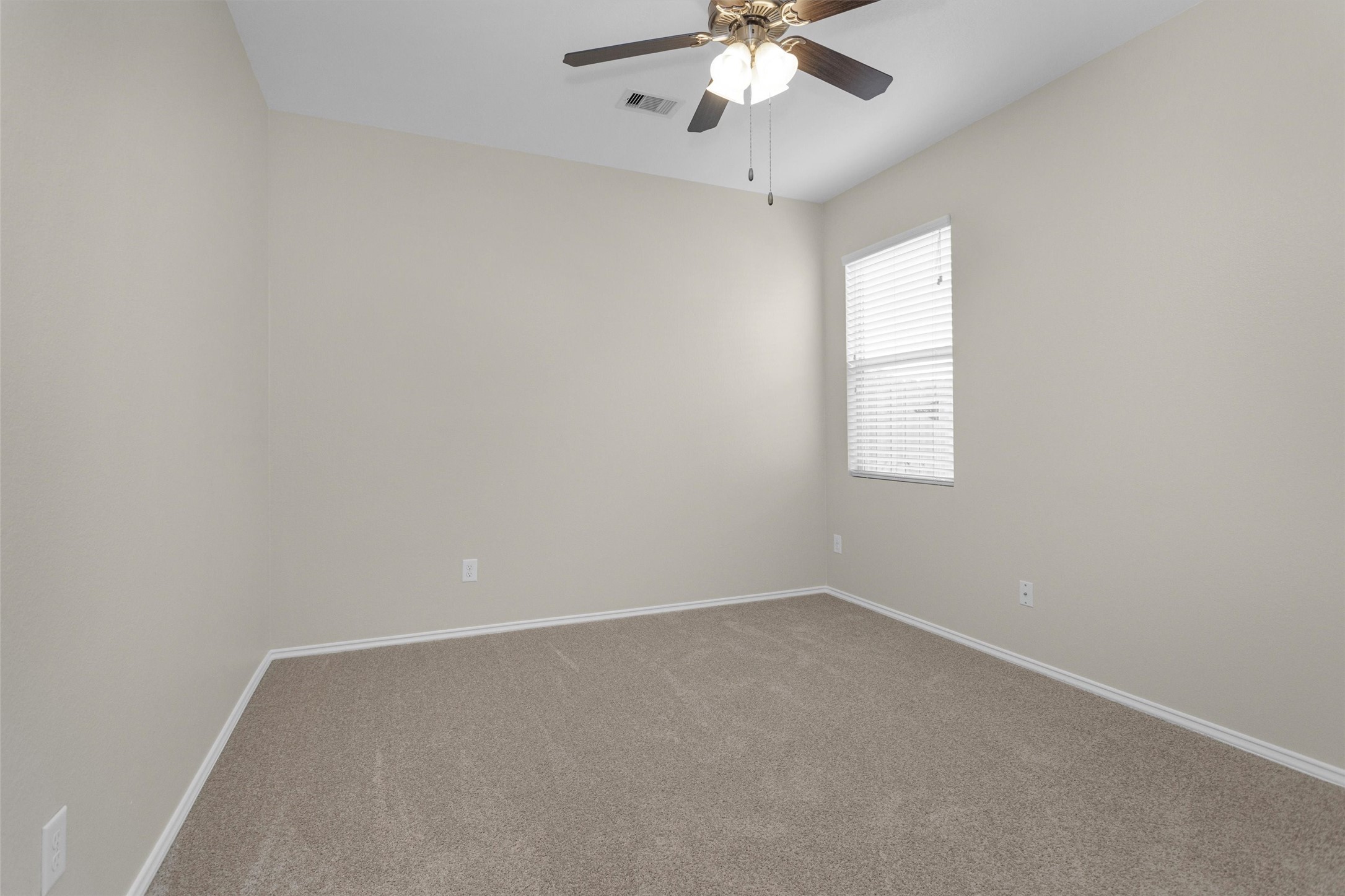 21419 Fossil Trails Drive Spring, TX 77388 - Photo 26 of 42 an empty room with a chandelier fan and windows