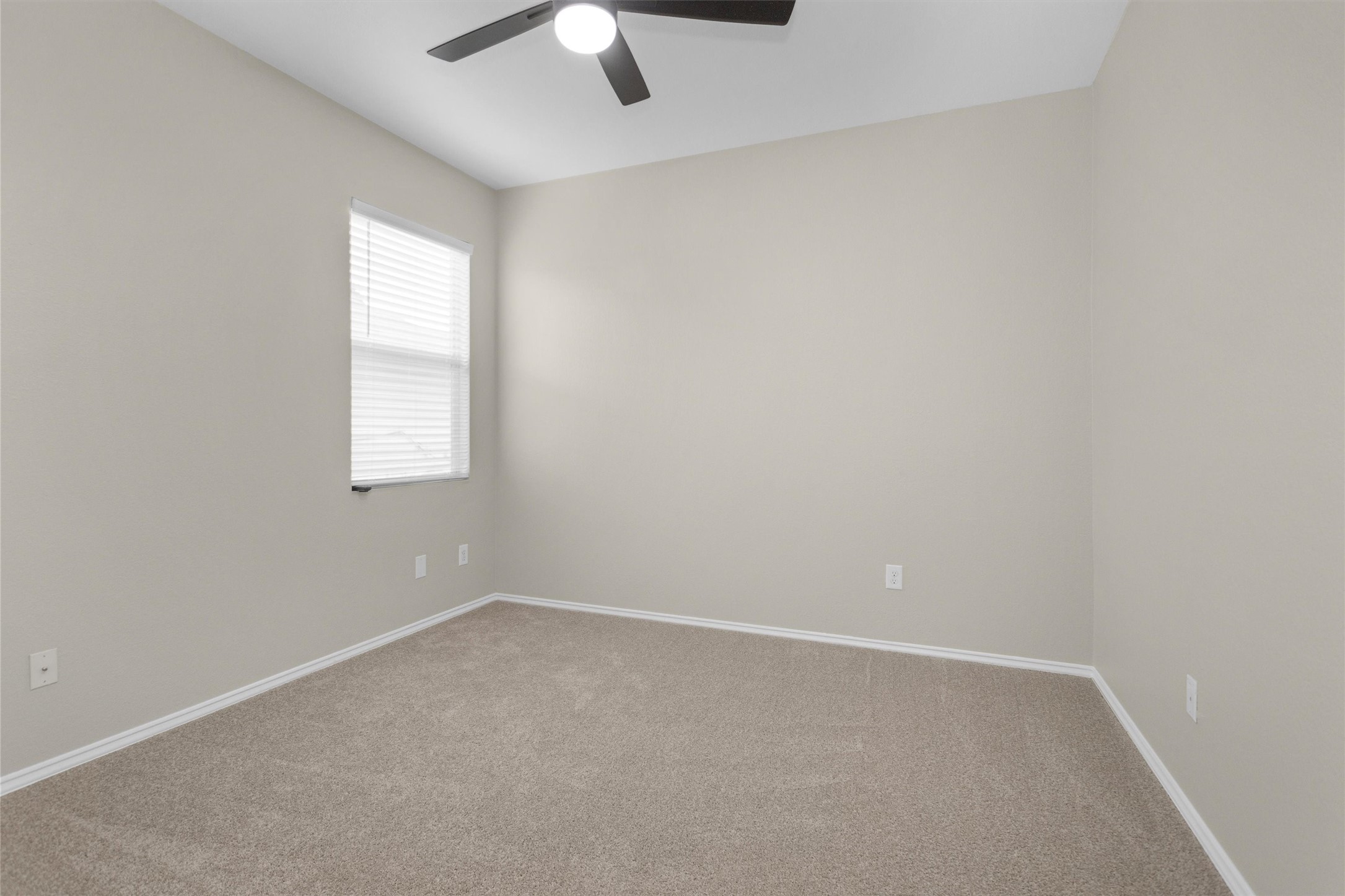 21419 Fossil Trails Drive Spring, TX 77388 - Photo 29 of 42 an empty room with a chandelier fan and windows