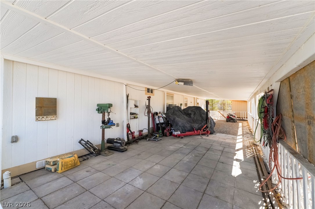 1551 West Wilson Road Pahrump, NV 89048 - Photo 38 of 68 A spacious covered carport features durable paved flooring and vertical siding.