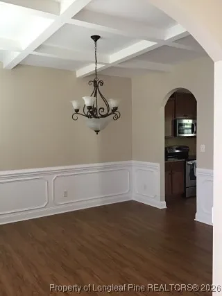 a view of a room with wooden floor and cabinets
