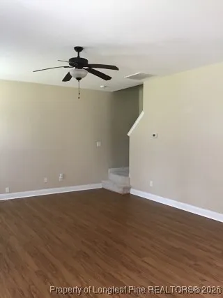 a view of a room with wooden floor