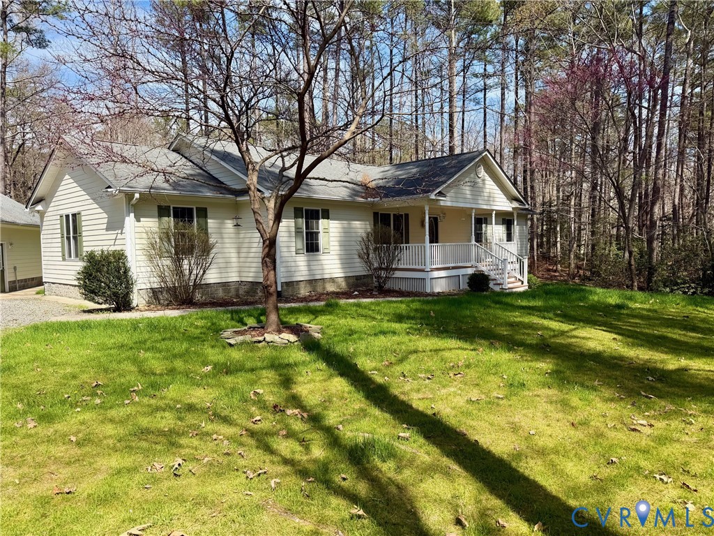 a front view of a house with yard and green space