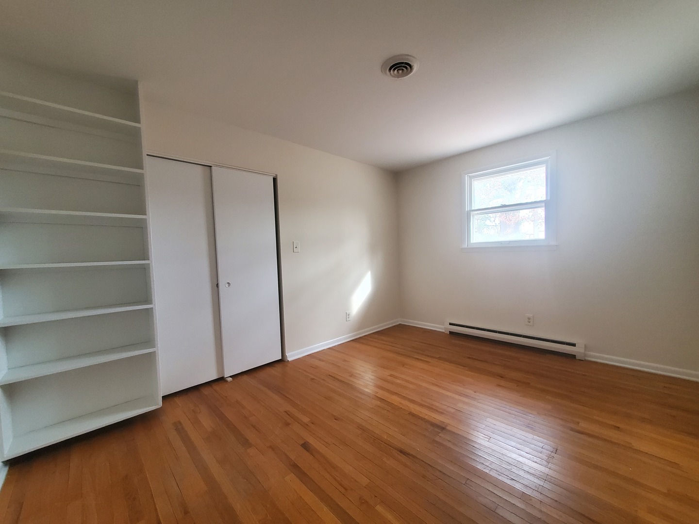 17162 South Lily Cache Road Plainfield, IL 60586 - Photo 8 of 21 a view of an empty room with wooden floor and a window