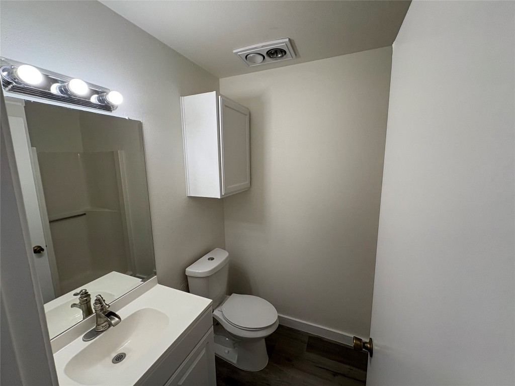 1128 Orchard Park Circle Pflugerville, TX 78660 - Photo 12 of 14 a bathroom with a sink toilet and shower