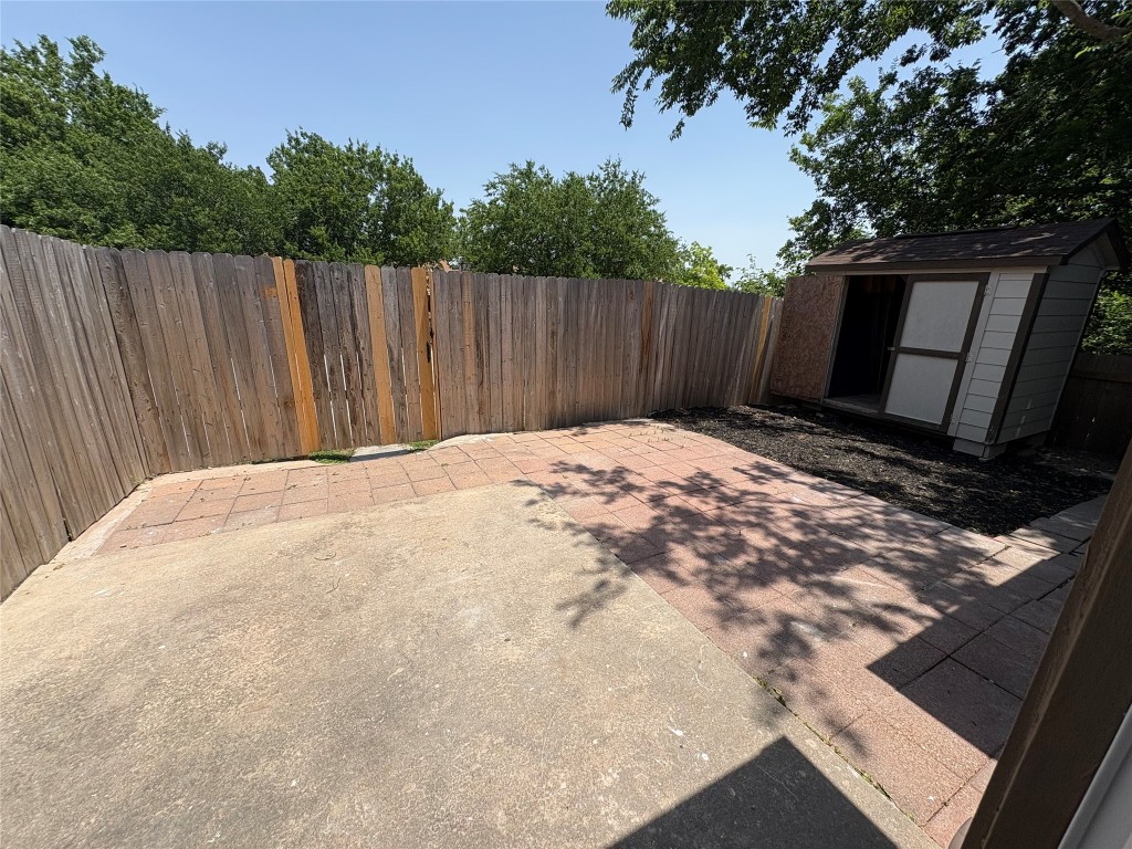 1128 Orchard Park Circle Pflugerville, TX 78660 - Photo 14 of 14 a view of a backyard with wooden fence