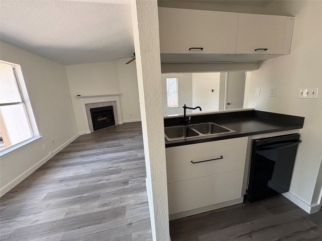 1128 Orchard Park Circle Pflugerville, TX 78660 - Photo 6 of 14 a kitchen with a sink and cabinets