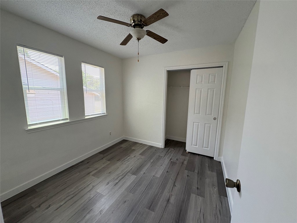 1128 Orchard Park Circle Pflugerville, TX 78660 - Photo 9 of 14 a view of an empty room with wooden floor and a window