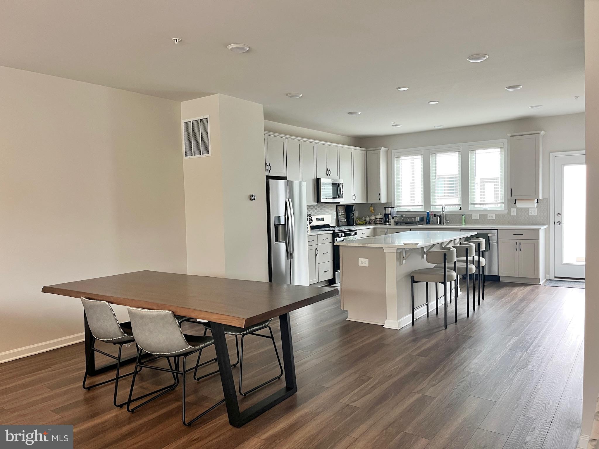 236 Mainstream Drive Laurel, MD 20724 - Photo 15 of 52 a view of a dining room with furniture and wooden floor